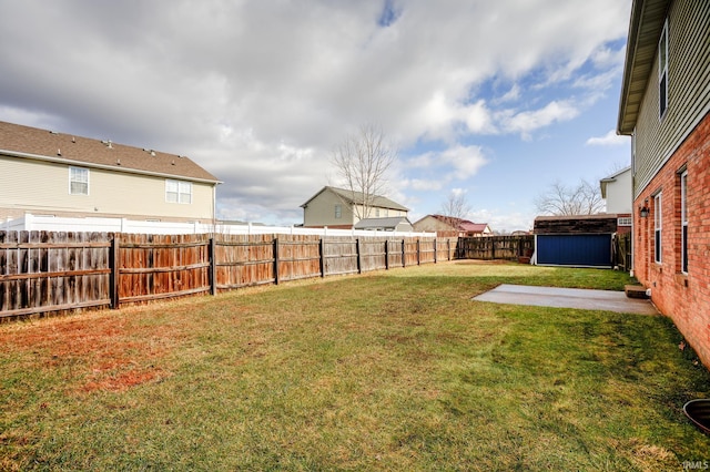 view of yard featuring a patio and a storage unit