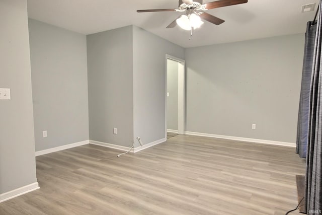 empty room featuring ceiling fan and light wood-type flooring