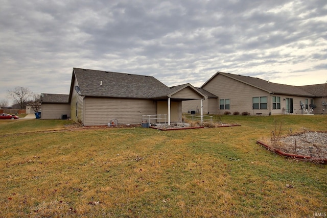 rear view of house with a yard