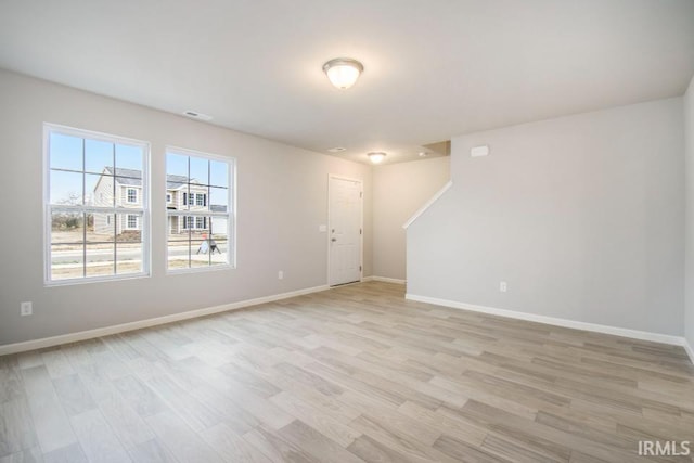 spare room with light wood-type flooring