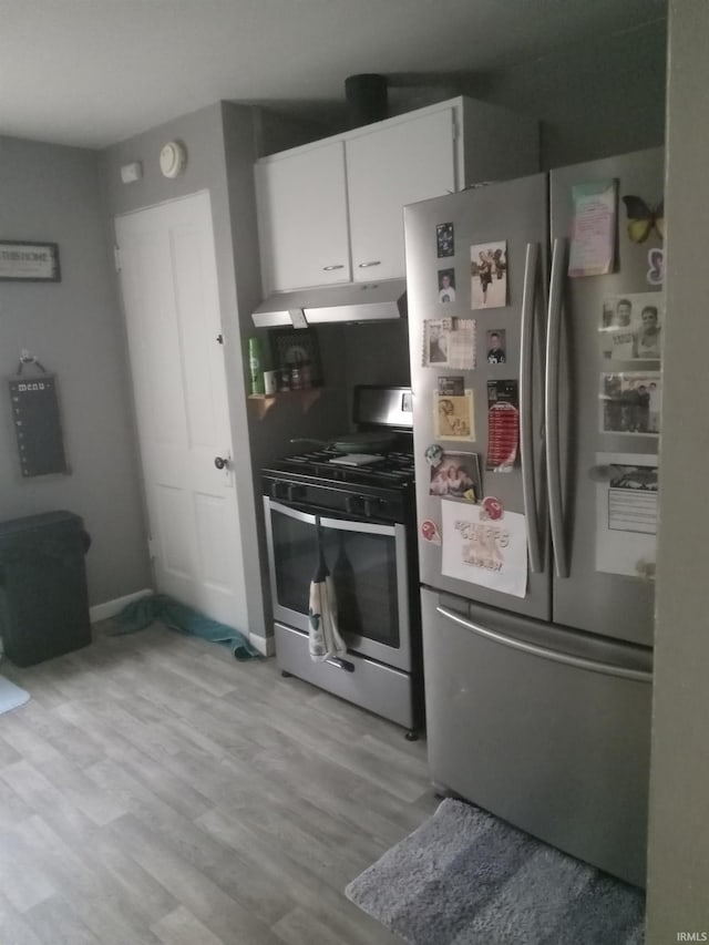 kitchen featuring appliances with stainless steel finishes, white cabinets, and light hardwood / wood-style floors