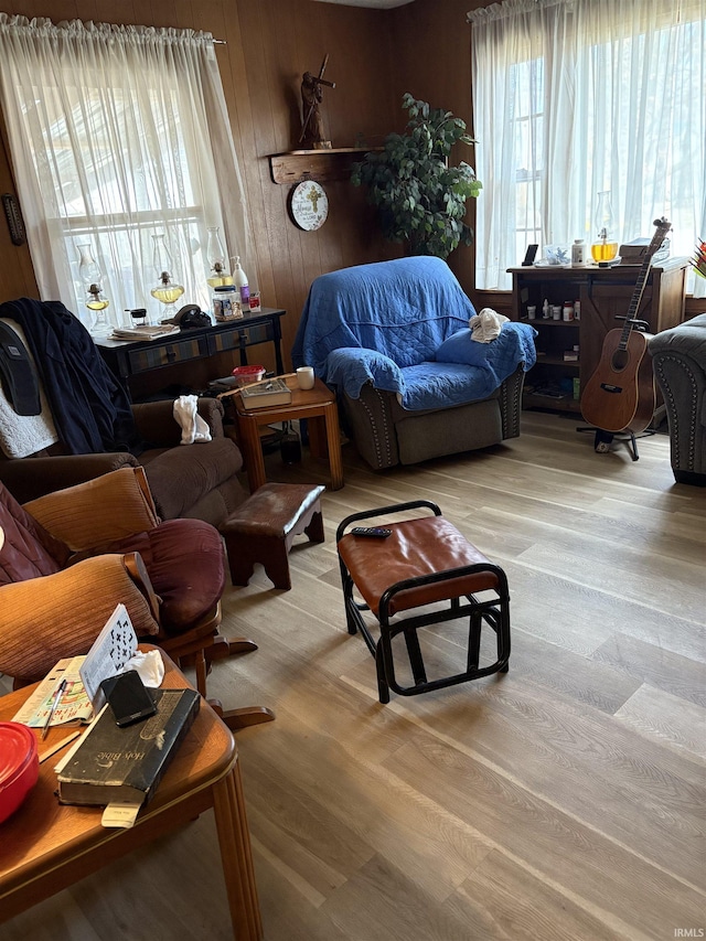 living room featuring wooden walls and light hardwood / wood-style flooring