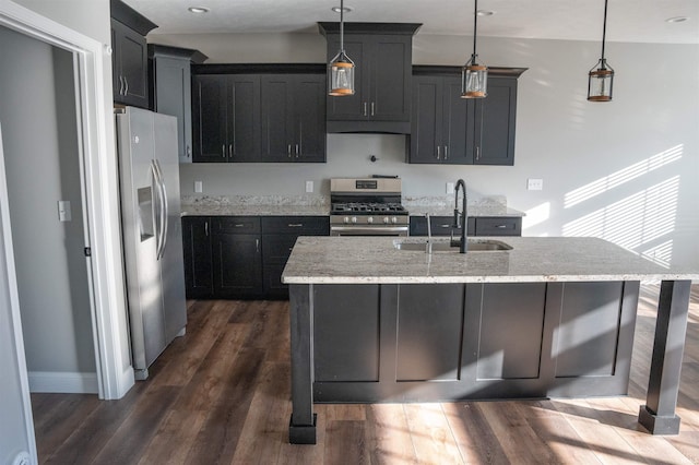 kitchen featuring pendant lighting, appliances with stainless steel finishes, sink, and light stone counters