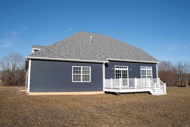 rear view of property with a lawn and a deck