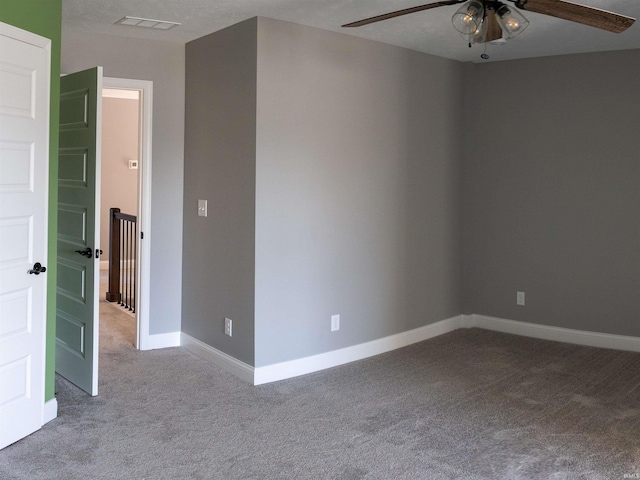 unfurnished room with ceiling fan and light carpet