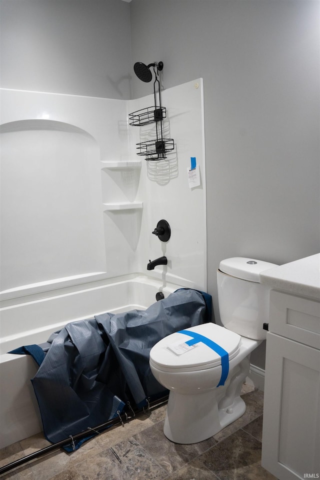 bathroom featuring shower / bath combination and toilet