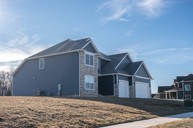 view of home's exterior featuring a garage and central air condition unit