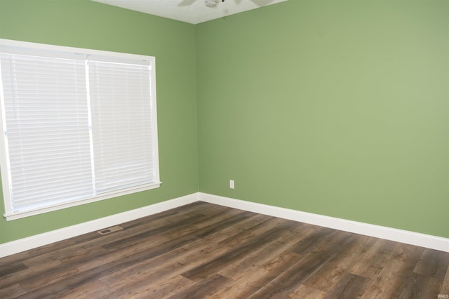 unfurnished room with dark hardwood / wood-style floors