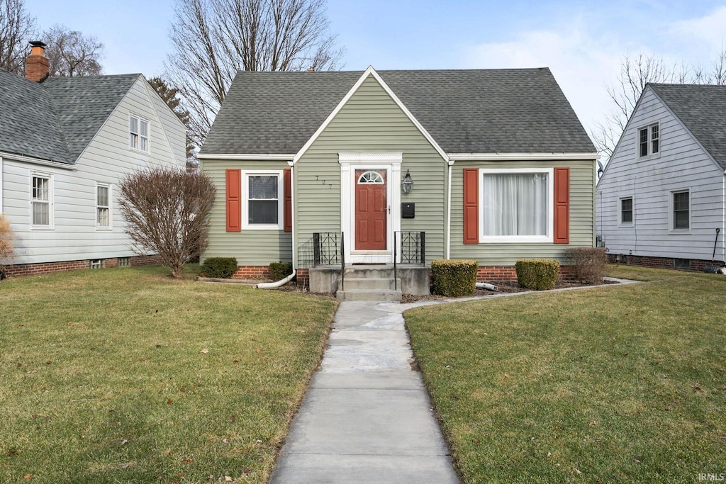 bungalow-style home with a front lawn