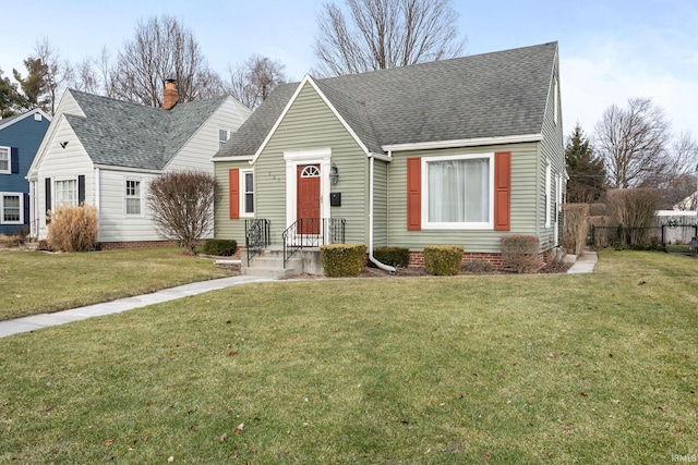 cape cod house featuring a front yard