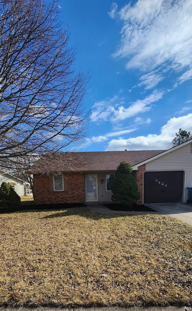 single story home featuring a garage and a front lawn