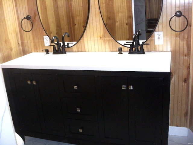 bathroom with vanity and wooden walls