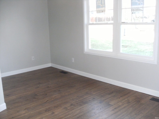 spare room featuring dark hardwood / wood-style flooring