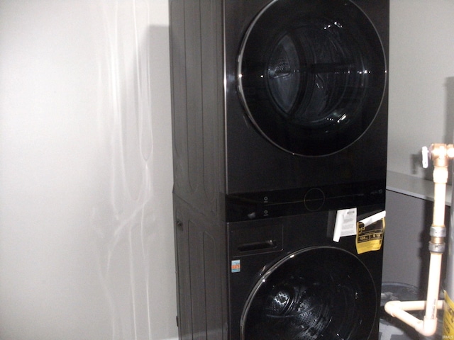 laundry area with stacked washer / drying machine