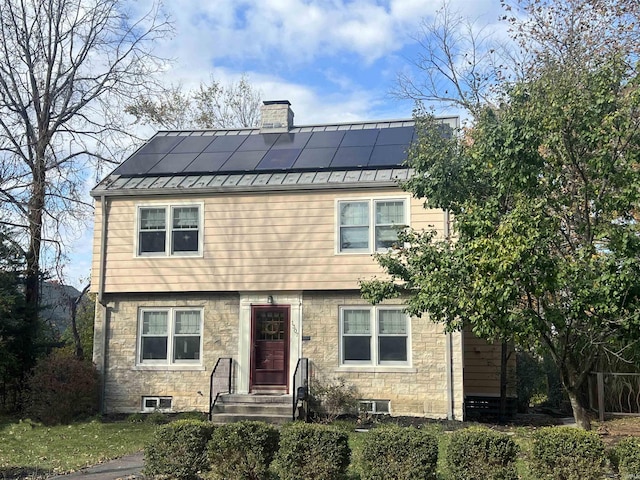 view of front facade featuring solar panels