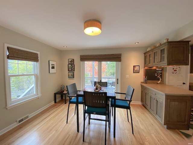 dining space with light hardwood / wood-style floors