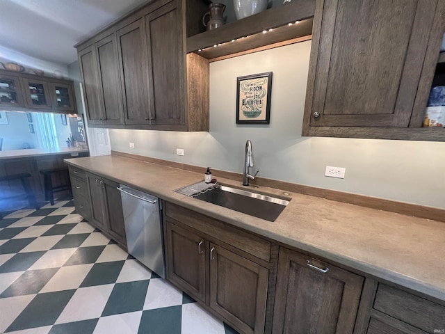 kitchen with stainless steel dishwasher, sink, and dark brown cabinets