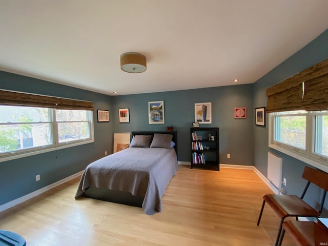 bedroom featuring light hardwood / wood-style floors and multiple windows