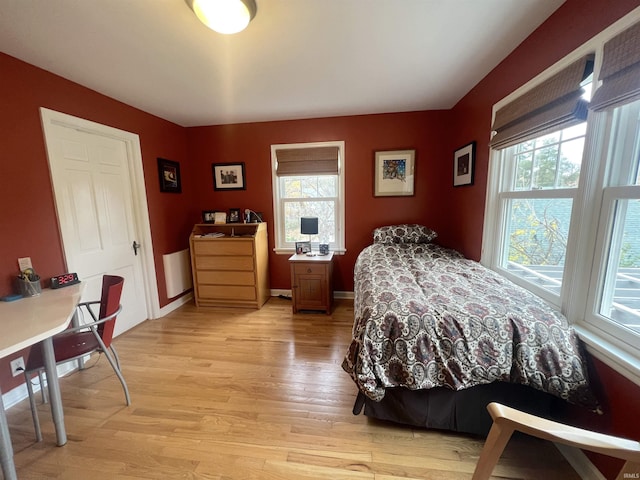 bedroom featuring multiple windows and light wood-type flooring