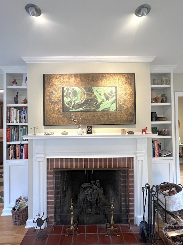 room details with ornamental molding, a brick fireplace, and built in features