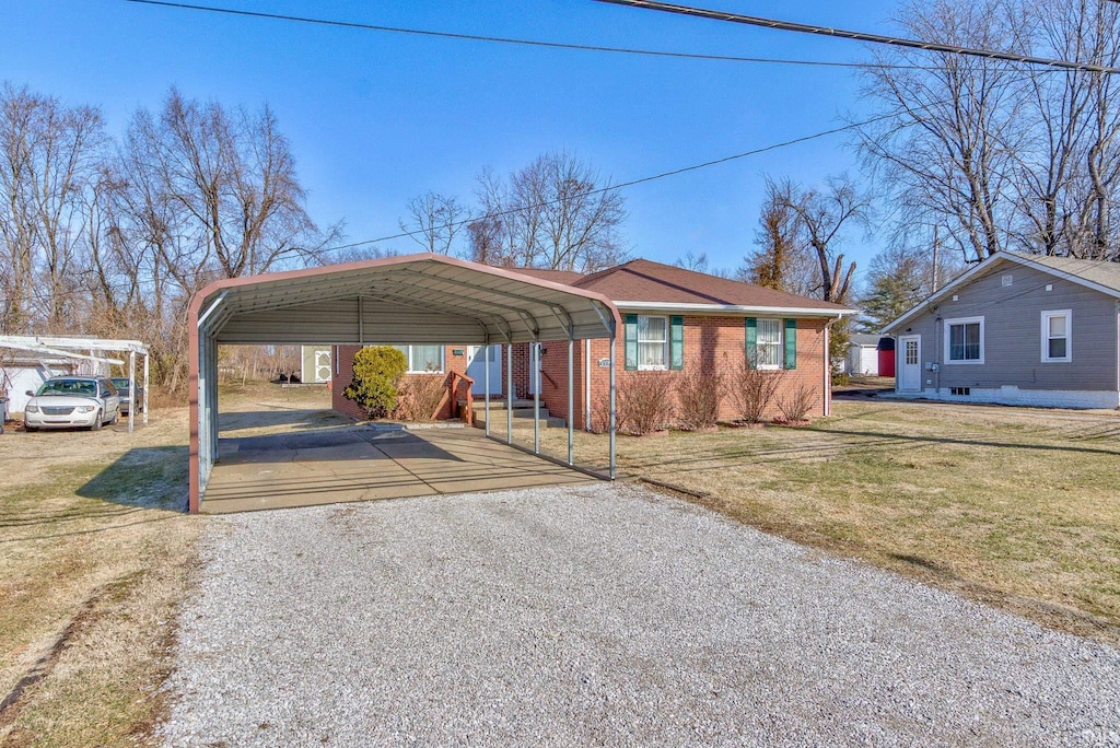 view of car parking with a carport and a yard