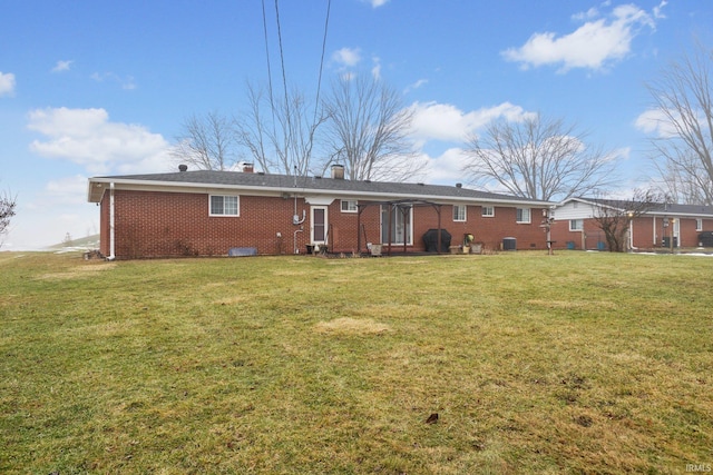 rear view of house featuring a lawn