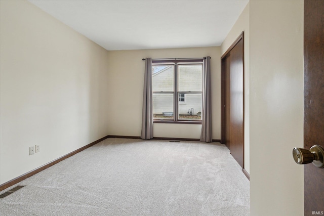 unfurnished room with light carpet