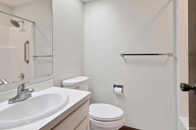 bathroom with vanity, a shower, and toilet