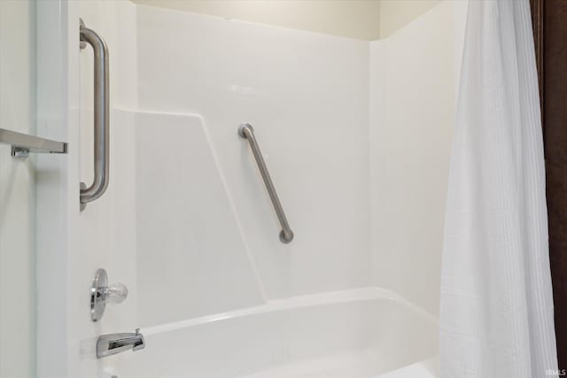 bathroom with shower / bath combo with shower curtain