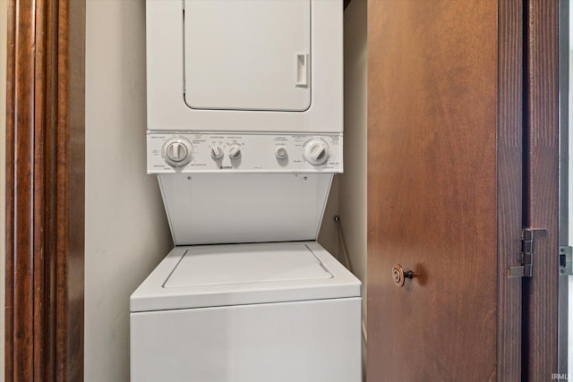 laundry room with stacked washer / dryer