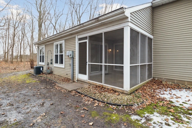 exterior space with a sunroom and central AC