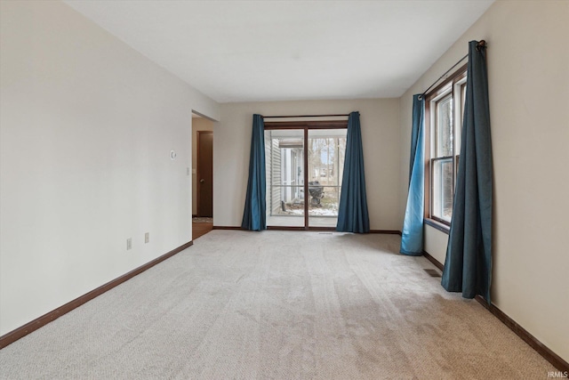 unfurnished room featuring light colored carpet