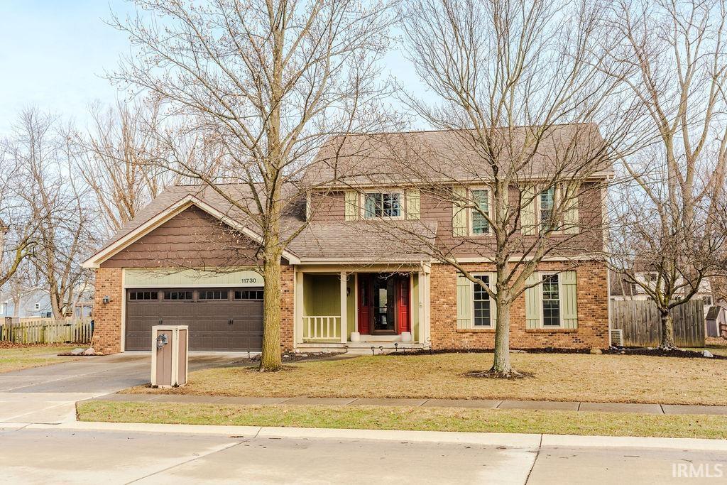 view of front of house with a garage and a front lawn