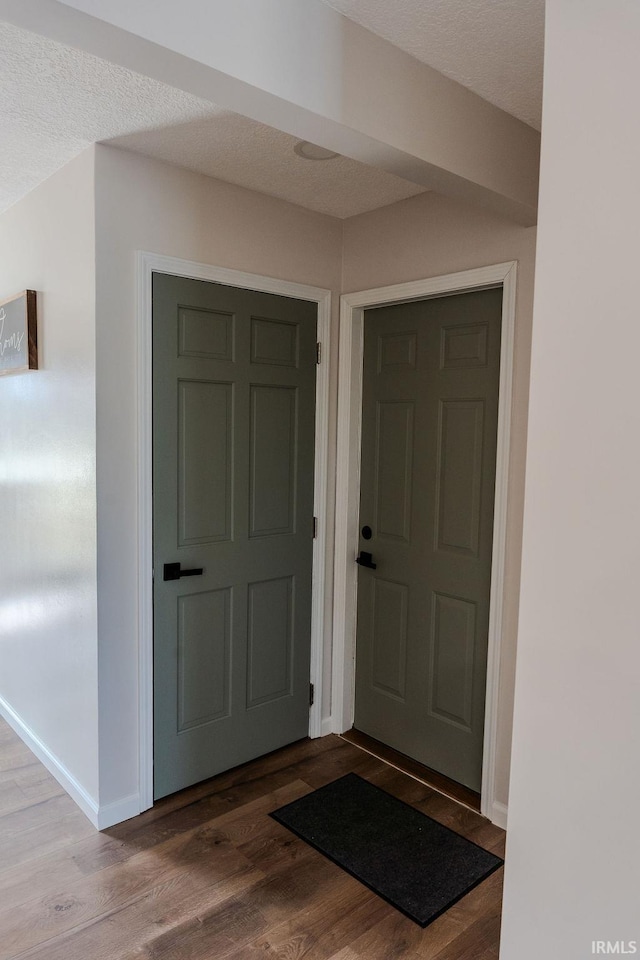 interior space with wood-type flooring and a textured ceiling