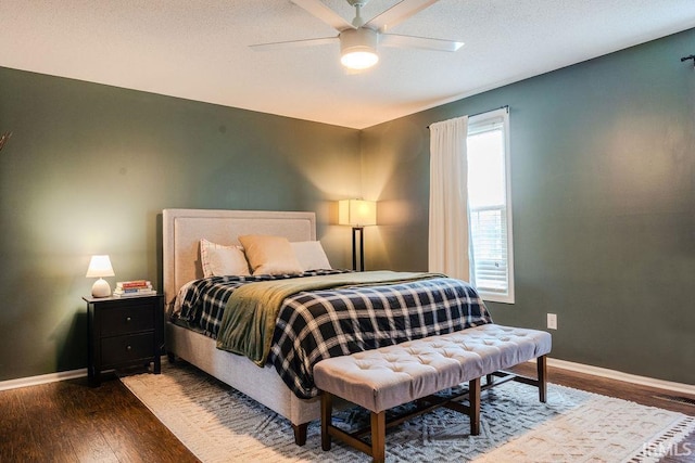 bedroom with dark wood-type flooring and ceiling fan