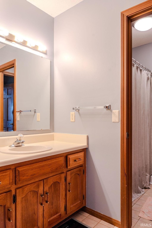 bathroom with tile patterned floors and vanity