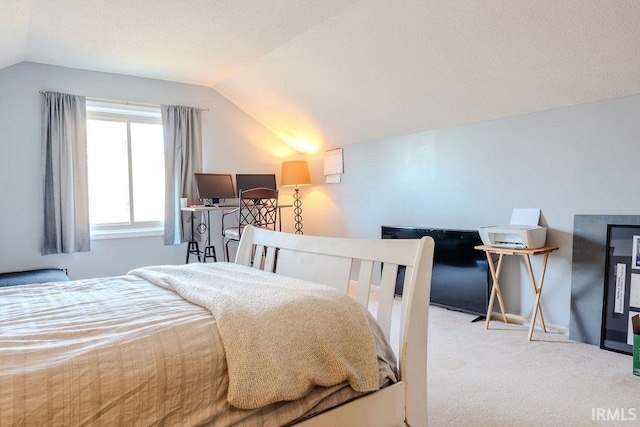 carpeted bedroom with lofted ceiling