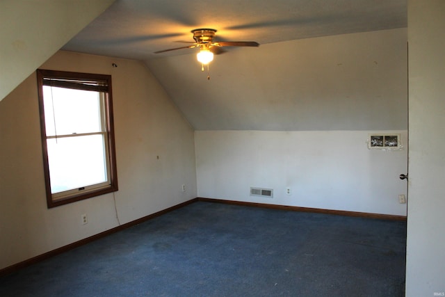 bonus room featuring ceiling fan, vaulted ceiling, and dark colored carpet