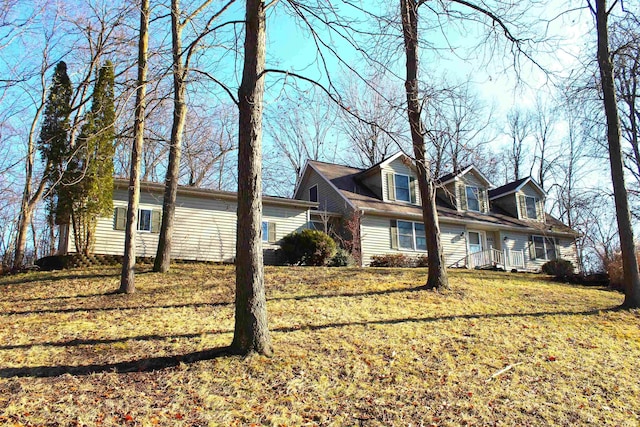 view of side of home with a yard