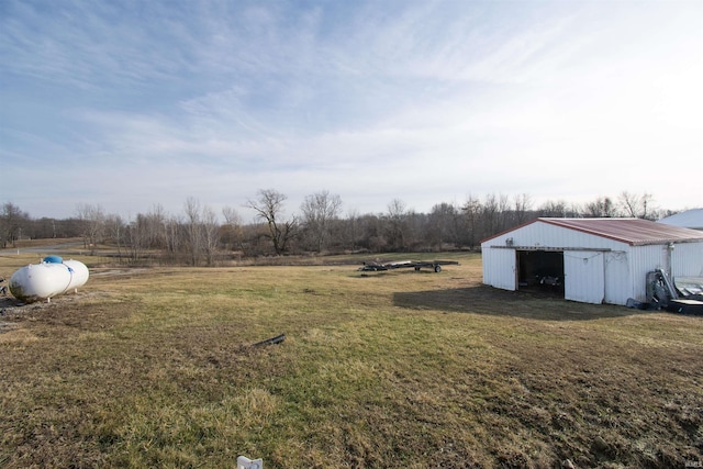 view of yard with an outbuilding and a rural view