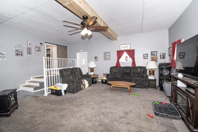 carpeted living room with ceiling fan and a barn door