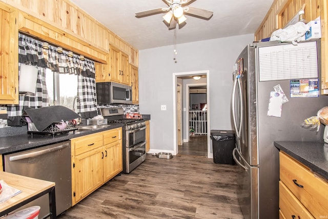 kitchen featuring light brown cabinetry, backsplash, ceiling fan, stainless steel appliances, and dark wood-type flooring