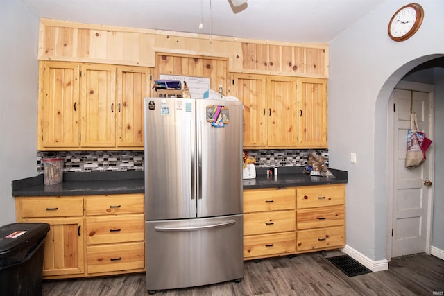 kitchen featuring stainless steel refrigerator, dark hardwood / wood-style flooring, light brown cabinetry, and backsplash