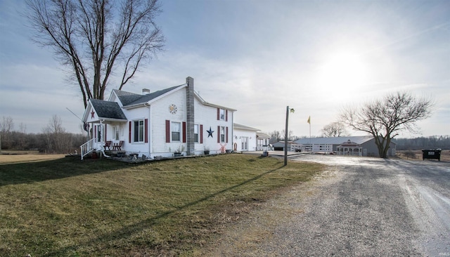 view of side of home featuring a yard