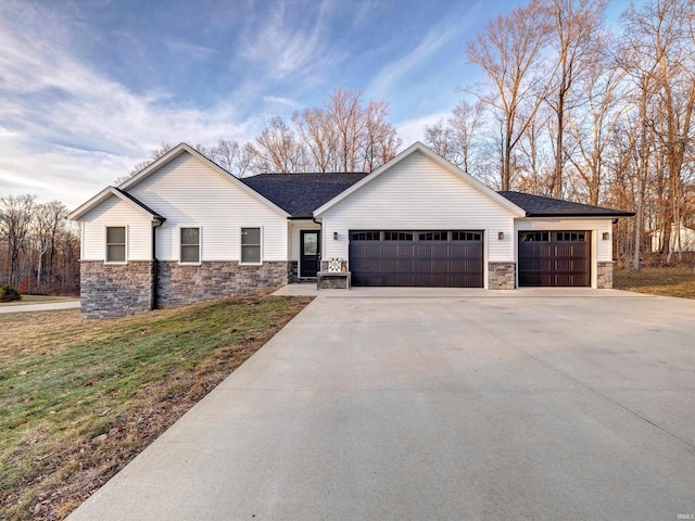 view of front of property featuring a garage and a front lawn