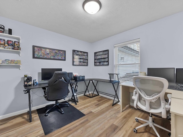 home office with wood-type flooring and a textured ceiling