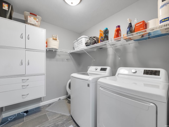 clothes washing area featuring independent washer and dryer and a textured ceiling