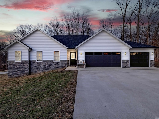 view of front of house featuring a garage and a lawn