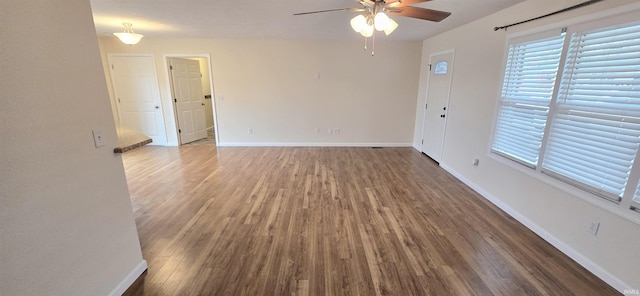 unfurnished room featuring dark hardwood / wood-style floors and ceiling fan