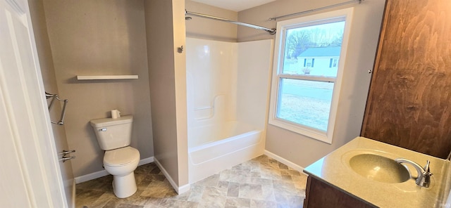 full bathroom featuring a healthy amount of sunlight, toilet,  shower combination, and vanity